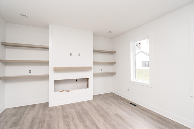 17987 Alpine Dr, Clive, IA 50325 - unfurnished living room featuring wood finished floors and baseboards