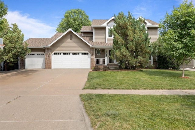1305 NW Wagner Blvd, Ankeny, IA 50023 - view of front facade featuring an attached garage, driveway, a front yard, brick siding, and covered porch