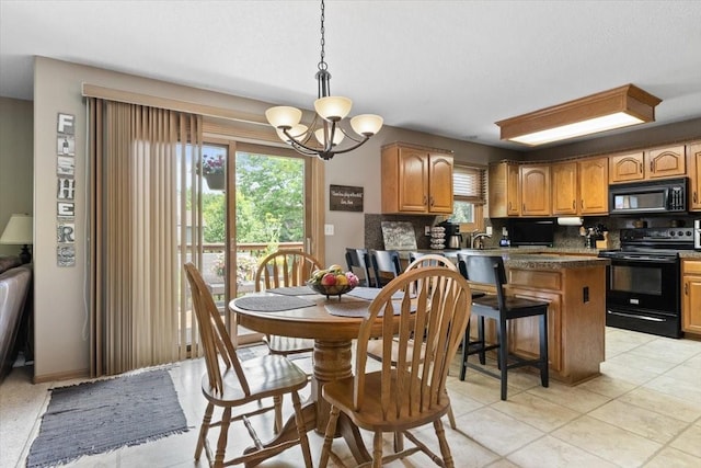 1305 NW Wagner Blvd, Ankeny, IA 50023 - dining space with healthy amount of natural light, a chandelier, and light tile patterned floors