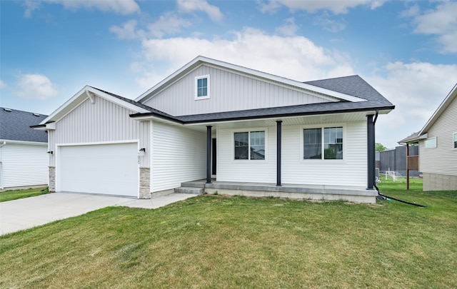 7825 SE 2nd St, Des Moines, IA 50320 - view of front facade with covered porch, a garage, a front yard, and driveway