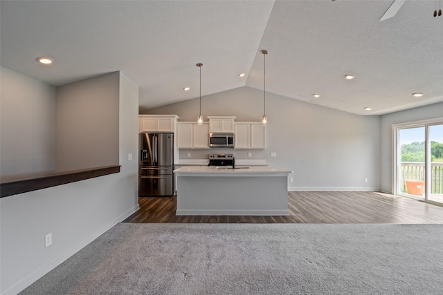 7825 SE 2nd St, Des Moines, IA 50320 - kitchen featuring appliances with stainless steel finishes, dark wood finished floors, white cabinetry, an island with sink, and lofted ceiling