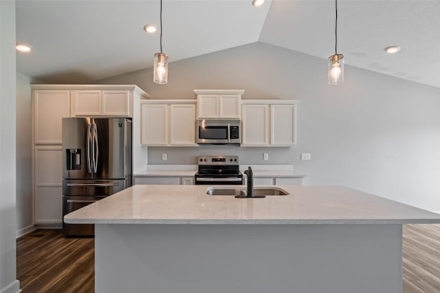 7825 SE 2nd St, Des Moines, IA 50320 - kitchen with appliances with stainless steel finishes, lofted ceiling, dark wood-style floors, hanging light fixtures, and white cabinetry