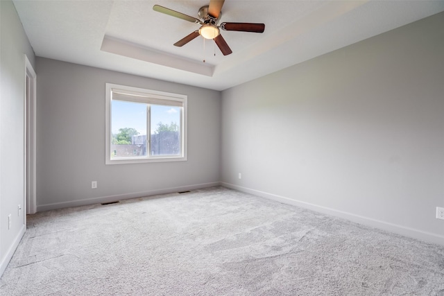 7825 SE 2nd St, Des Moines, IA 50320 - carpeted spare room with a tray ceiling and a ceiling fan
