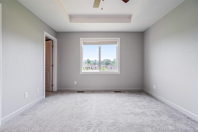 7825 SE 2nd St, Des Moines, IA 50320 - carpeted spare room featuring a tray ceiling and a ceiling fan