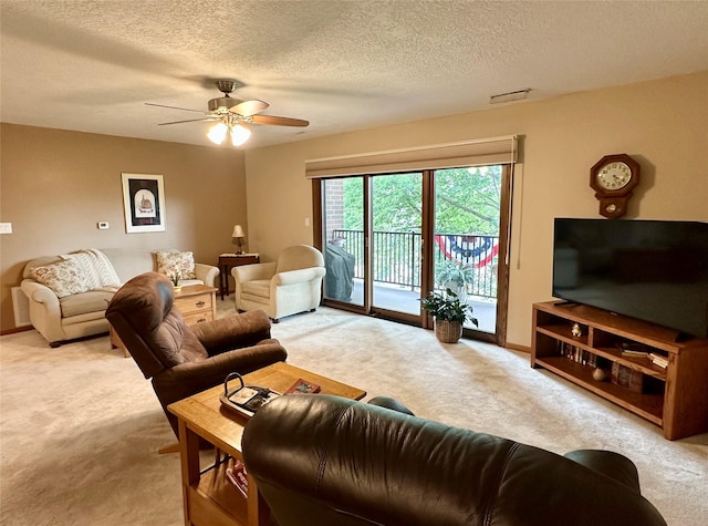 2005 Spring St Unit U203, Grinnell, IA 50112 - carpeted living room featuring ceiling fan and a textured ceiling