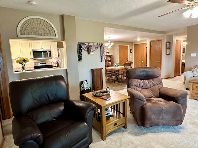2005 Spring St Unit U203, Grinnell, IA 50112 - living area featuring a chandelier, ceiling fan, and light colored carpet