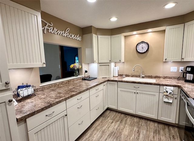 2005 Spring St Unit U203, Grinnell, IA 50112 - kitchen featuring light wood-style flooring, white cabinetry, recessed lighting, and dark stone counters