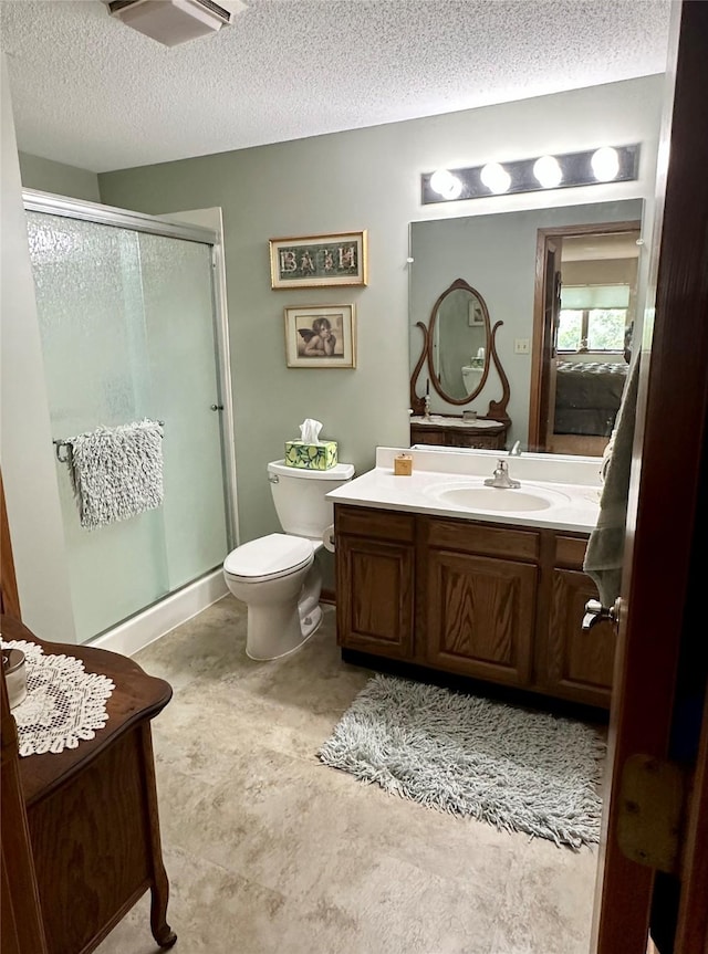2005 Spring St Unit U203, Grinnell, IA 50112 - bathroom featuring vanity, a shower stall, and a textured ceiling