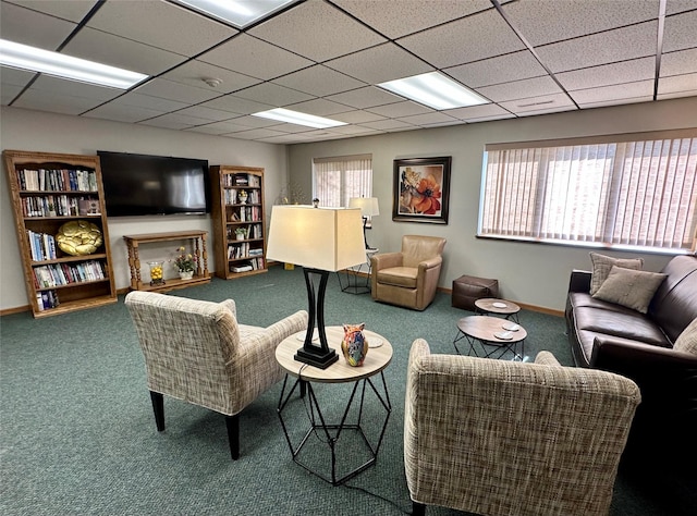 2005 Spring St Unit U203, Grinnell, IA 50112 - living area featuring carpet floors, plenty of natural light, and a paneled ceiling