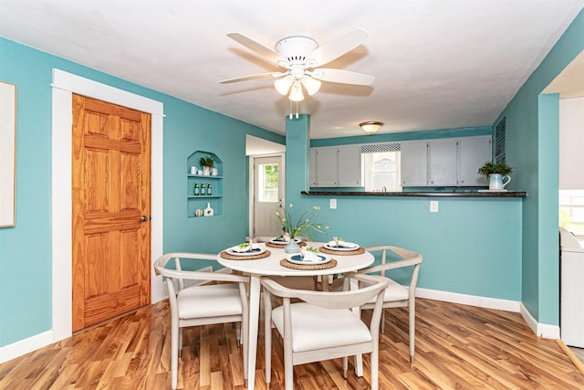 1229 9th St, Nevada, IA 50201 - dining space with a ceiling fan, light wood finished floors, and washer / dryer