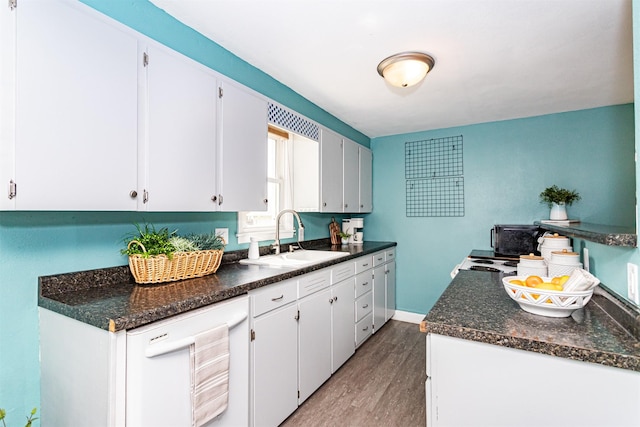 1229 9th St, Nevada, IA 50201 - kitchen featuring wood finished floors and white cabinets