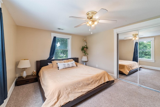 2800 E Douglas Ave, Des Moines, IA 50317 - bedroom featuring carpet, a closet, ceiling fan, and multiple windows