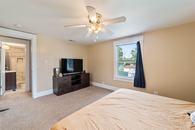 2800 E Douglas Ave, Des Moines, IA 50317 - carpeted bedroom featuring a ceiling fan and ensuite bathroom
