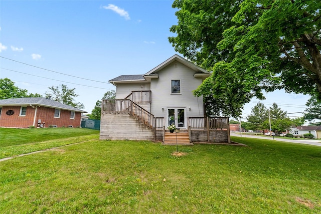 2800 E Douglas Ave, Des Moines, IA 50317 - back of property with stairs, a deck, and a lawn