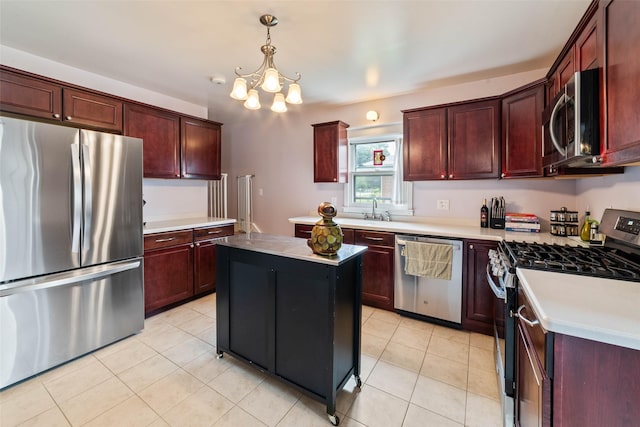 2800 E Douglas Ave, Des Moines, IA 50317 - kitchen with appliances with stainless steel finishes, a chandelier, light countertops, and light tile patterned floors