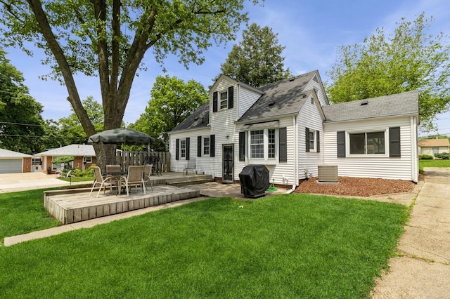 6420 Center St, Des Moines, IA 50312 - back of property featuring a patio, a lawn, and roof with shingles