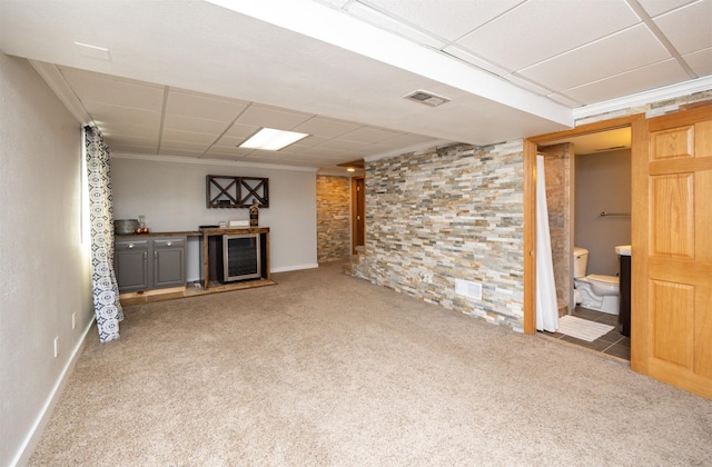 905 SE Meadowlark Dr, Grimes, IA 50111 - unfurnished living room featuring wine cooler, carpet floors, and a paneled ceiling