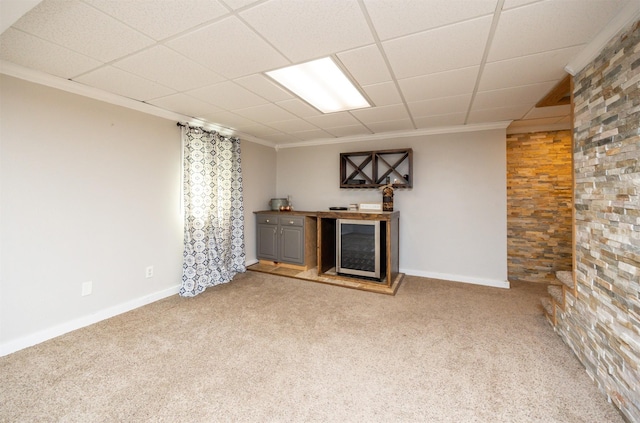 905 SE Meadowlark Dr, Grimes, IA 50111 - unfurnished living room with wine cooler, ornamental molding, a dry bar, and light colored carpet