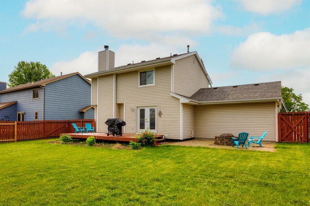 905 SE Meadowlark Dr, Grimes, IA 50111 - back of property with a fenced backyard, a deck, a fire pit, a chimney, and french doors