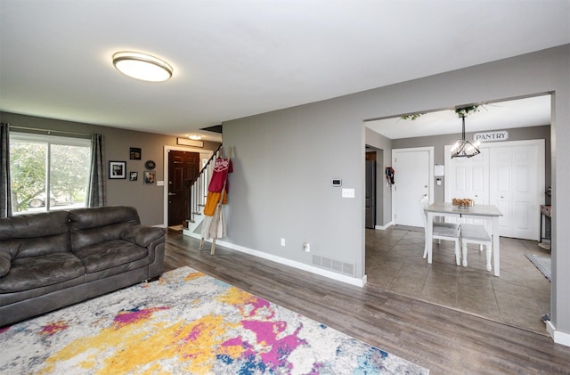 905 SE Meadowlark Dr, Grimes, IA 50111 - living room featuring stairway and wood finished floors