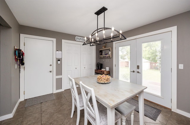 905 SE Meadowlark Dr, Grimes, IA 50111 - dining space with french doors, a chandelier, and dark tile patterned floors