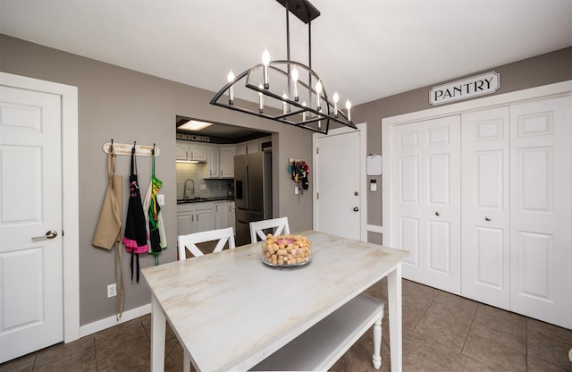 905 SE Meadowlark Dr, Grimes, IA 50111 - dining room featuring a chandelier and dark tile patterned floors