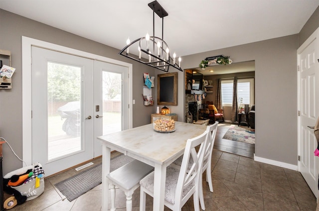 905 SE Meadowlark Dr, Grimes, IA 50111 - dining room with french doors, a chandelier, and dark tile patterned flooring