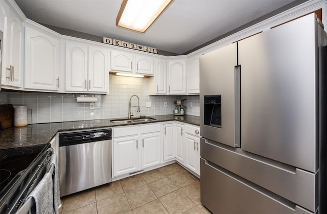 905 SE Meadowlark Dr, Grimes, IA 50111 - kitchen with appliances with stainless steel finishes, backsplash, light tile patterned floors, and white cabinetry