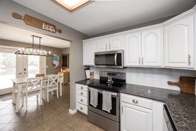 905 SE Meadowlark Dr, Grimes, IA 50111 - kitchen featuring appliances with stainless steel finishes, white cabinets, decorative backsplash, and light tile patterned flooring