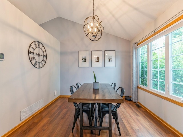 2015 NW 158th St, Clive, IA 50325 - dining space with vaulted ceiling, plenty of natural light, a chandelier, and wood finished floors