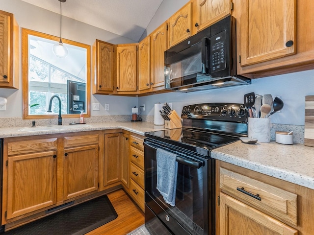 2015 NW 158th St, Clive, IA 50325 - kitchen with black appliances, vaulted ceiling, decorative light fixtures, light wood finished floors, and light stone countertops