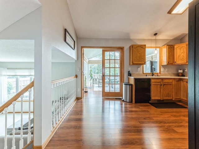 2015 NW 158th St, Clive, IA 50325 - kitchen with black dishwasher, dark wood finished floors, light countertops, decorative light fixtures, and lofted ceiling