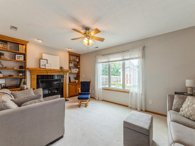 2015 NW 158th St, Clive, IA 50325 - living room featuring light colored carpet, a fireplace, ceiling fan, and a textured ceiling