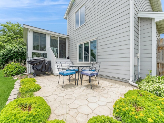 2015 NW 158th St, Clive, IA 50325 - view of patio / terrace with area for grilling, a sunroom, and outdoor dining space