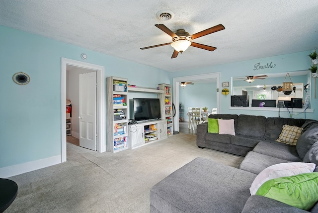455 NW 2nd St, Earlham, IA 50072 - living area with a ceiling fan, a textured ceiling, and carpet floors