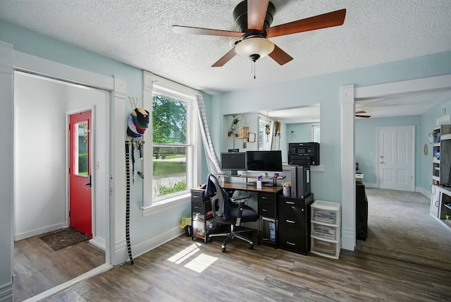 455 NW 2nd St, Earlham, IA 50072 - home office featuring a ceiling fan, wood finished floors, plenty of natural light, and a textured ceiling