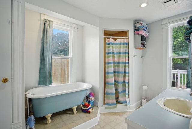 455 NW 2nd St, Earlham, IA 50072 - full bathroom with a shower stall, a soaking tub, and vanity