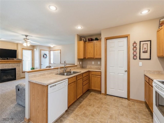 2005 E 1st Ave, Indianola, IA 50125 - kitchen with white appliances, a peninsula, a ceiling fan, a fireplace, and light countertops
