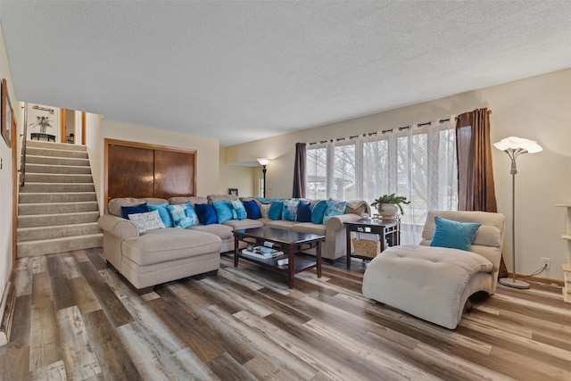 102 Kellogg Ave, Dallas Center, IA 50063 - living area featuring a textured ceiling, wood finished floors, and stairway