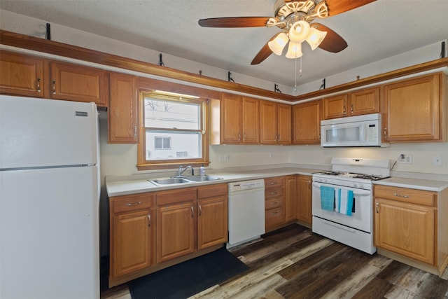 102 Kellogg Ave, Dallas Center, IA 50063 - kitchen with white appliances, dark wood-style flooring, light countertops, a ceiling fan, and brown cabinets