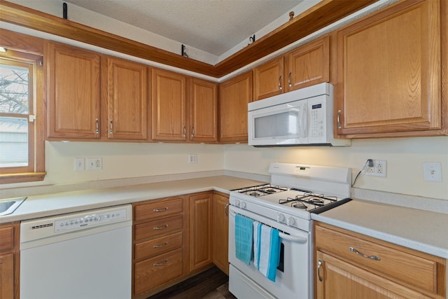 102 Kellogg Ave, Dallas Center, IA 50063 - kitchen featuring white appliances, light countertops, a textured ceiling, and brown cabinetry