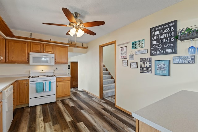 102 Kellogg Ave, Dallas Center, IA 50063 - kitchen featuring white appliances, dark wood-style flooring, a ceiling fan, light countertops, and brown cabinets