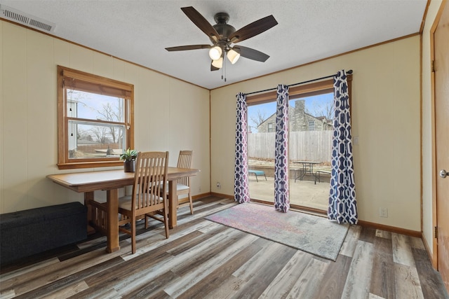 102 Kellogg Ave, Dallas Center, IA 50063 - dining room with wood finished floors, ceiling fan, crown molding, and a textured ceiling