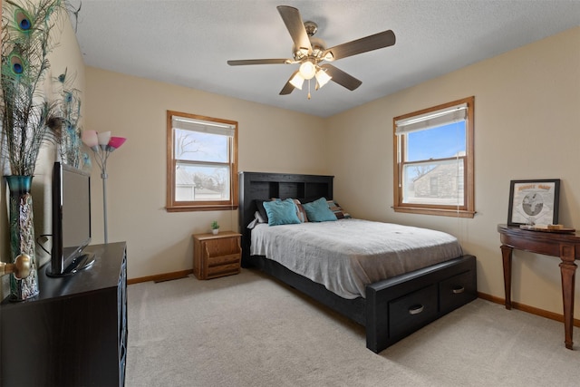 102 Kellogg Ave, Dallas Center, IA 50063 - bedroom featuring light carpet, ceiling fan, and a textured ceiling