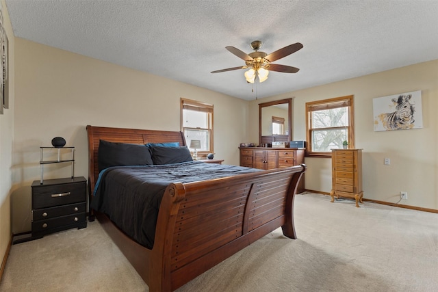 102 Kellogg Ave, Dallas Center, IA 50063 - bedroom featuring light colored carpet, a ceiling fan, and a textured ceiling