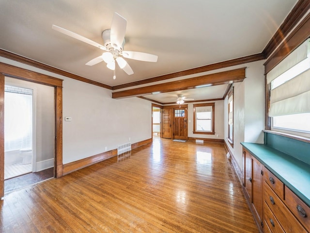 3324 Rollins Ave, Des Moines, IA 50312 - unfurnished living room featuring crown molding, a ceiling fan, and light wood-style floors