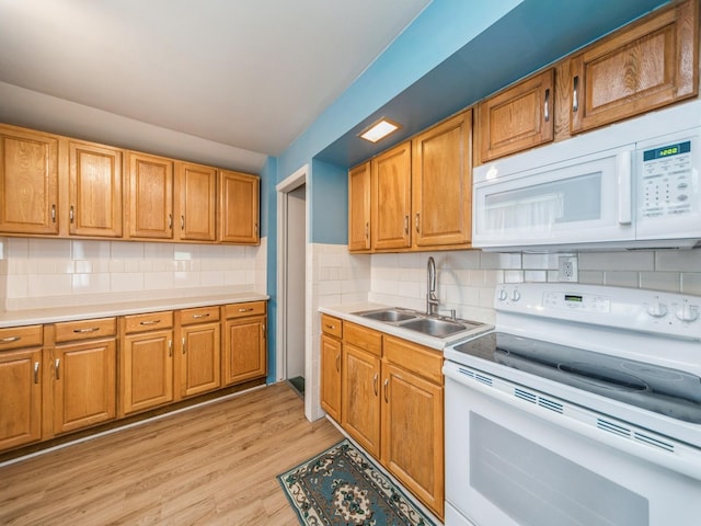 3324 Rollins Ave, Des Moines, IA 50312 - kitchen featuring white appliances, light countertops, light wood-style flooring, and backsplash
