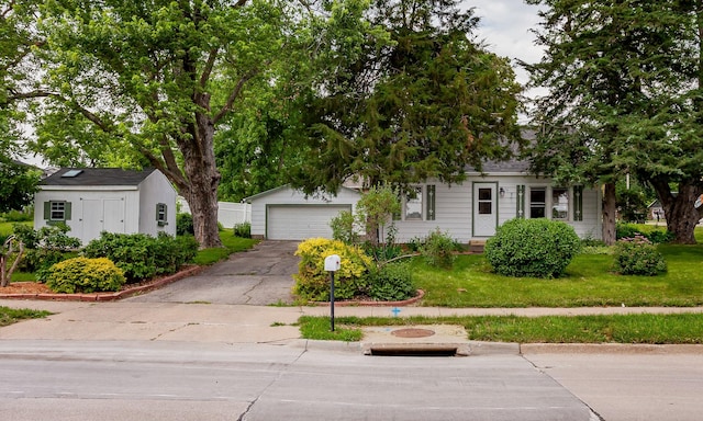 16 E Leach Ave, Des Moines, IA 50315 - view of property hidden behind natural elements with a front yard and asphalt driveway