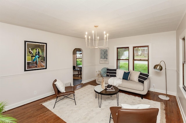 16 E Leach Ave, Des Moines, IA 50315 - living area featuring arched walkways, a chandelier, and wood finished floors