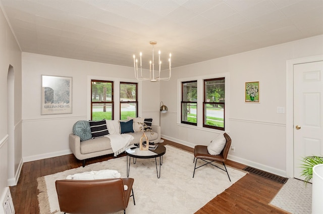 16 E Leach Ave, Des Moines, IA 50315 - living area featuring a chandelier and wood finished floors